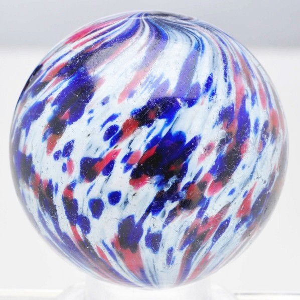 Large Onionskin Marble.: White base onionskin with great spotting of cobalt and red. Minor surface wear. Size: 2 - 1/16" Dia.