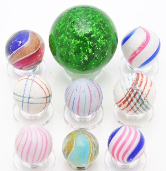 Lot of 9: Handmade Marbles.: Largest is a green mica. Lot also includes two ribbon Lutz, two clambroths, two geometric chinas, and two peppermint swirls. Size: Range: 5/8" to 1 - 1/4" Dia.