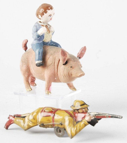 Lot of 2: Vintage Toy Items.: Includes one man riding pig candy container (possibly German) with repair to pig's leg and man's head. Also includes one tin litho Marx WWI-type soldier wind-up toy. Size: Largest: 7 - 1/2" L.