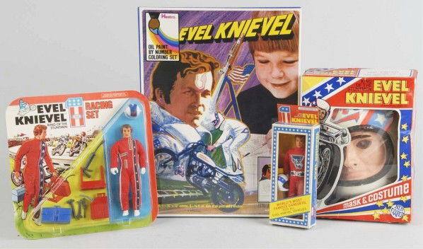 Lot of 4: Evel Knievel Items.: Circa 1970s. Includes Halloween costume and mask (with small crack), sealed paint set, Ideal action figure, and Ideal racing set sealed on card. Size: Largest Box: 12 - 1/4" x 16 - 1/2".