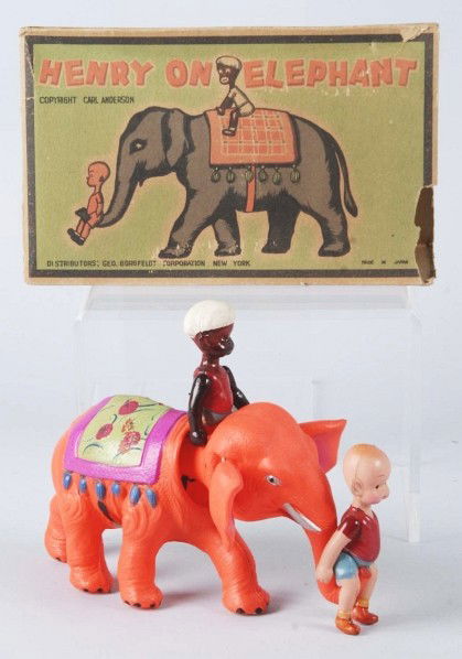 Celluloid Henry on Elephant Wind-Up Toy.: Japanese. Pre-war. Orange elephant variation. No dents but Mahout's legs need to be re-strung. Includes partial original box marked "Copyright Carl Anderson". Size: 8" L.
