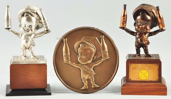 Lot of 3: Perky Dr. Pepper Items.: Description Includes 1940-1950s statuettes and one round six-inch plaque. Only the lightest of any marks or wear overall. Condition (Near Mint). Size Largest: 8" T.
