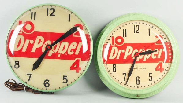 Lot of 2: Dr. Pepper Clocks.: Description 1950s. Includes one electric clock and one light-up clock. Fairly heavy crazing to the fiberboard case of the electric clock with possible repaint as well. Light-up clock has some fairly u