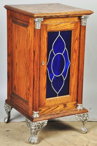 Oak Slot Machine Stand.: Description Cast iron feet and stained glass front. Includes lock and key. Condition (Excellent). Size 33 - 1/2" T.