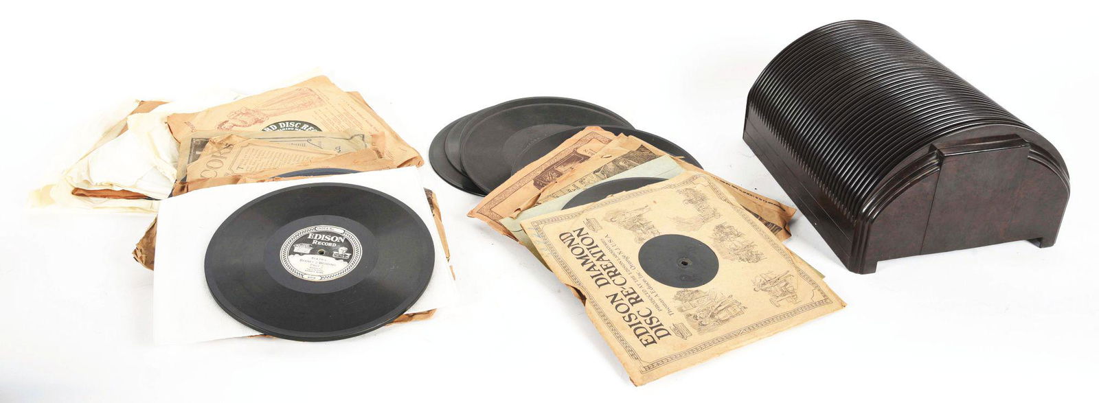 LARGE LOT OF RECORDS WITH AN ORIGINAL BAKELITE RECORD STAND. (1 of 2)