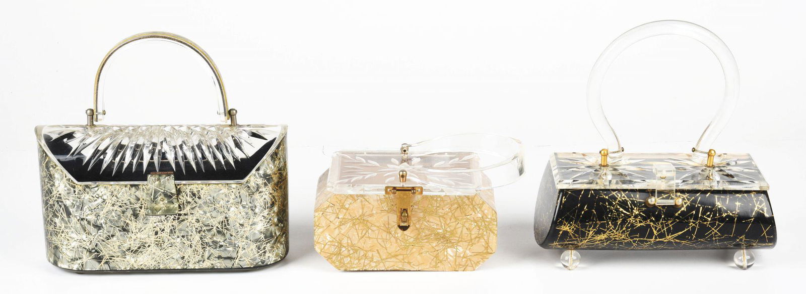 LOT OF 3: FLORIDA CONFETTI LUCITE HANDBAGS.: This lot consists of three Florida gold confetti Lucite handbags, with clear artesian tops and handles. Minor age and use related wear. Condition: (Very Good). Dimensions: Largest: 9" x 3 - 1/4" x 8 -