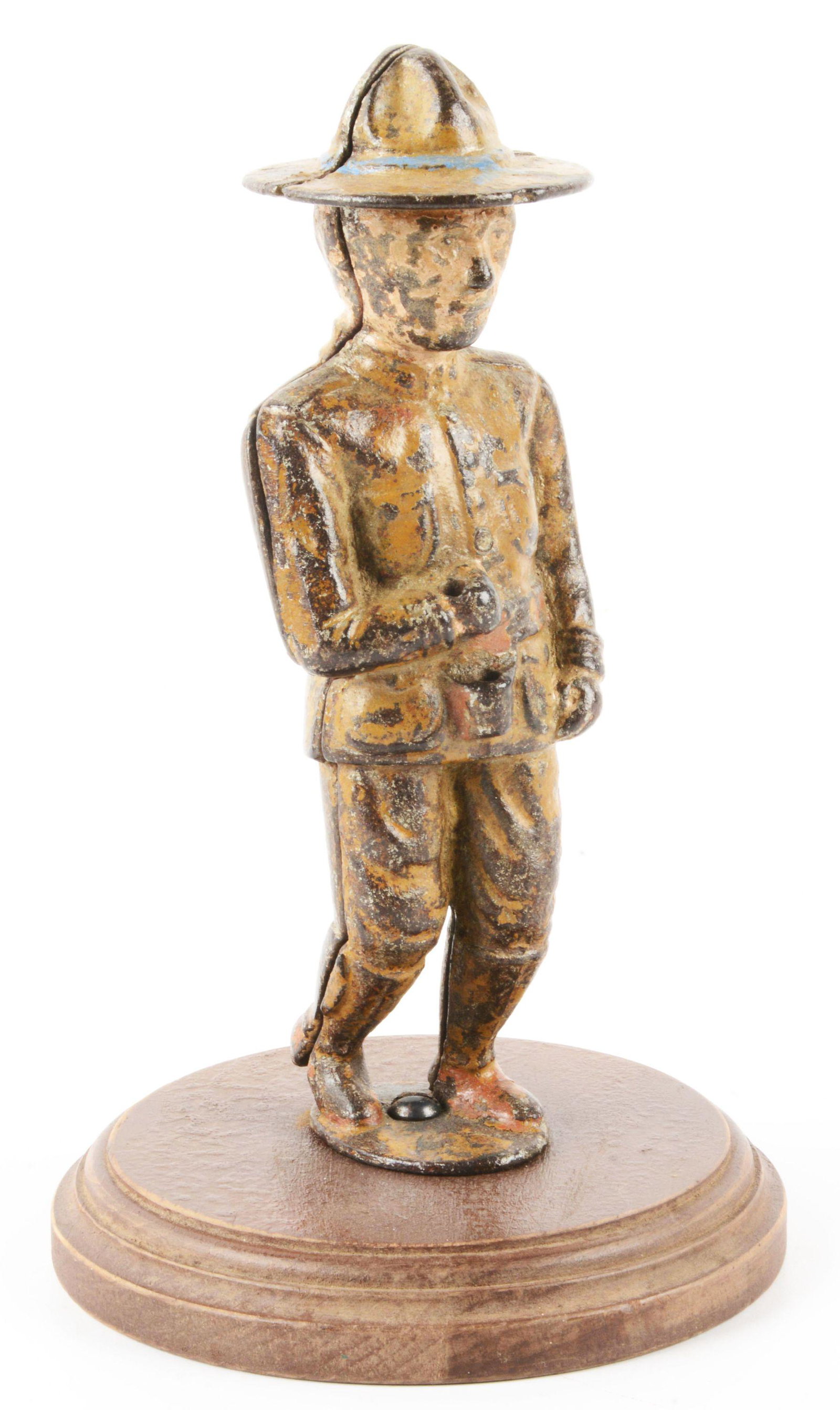CAST IRON WITH WOODEN BASE DOUGHBOY SOLDER STILL BANK.: Missing flag in hands. Original gold painting with blue trim on hat. Wooden base. Tan belt and ammunition box. Moderate general overall paint loss and wear. Condition: (Very Good). Dimensions: 7 - 1/2