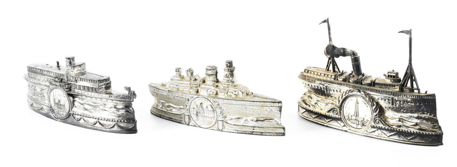 LOT OF 3: EUROPEAN DIE-CAST SHIP STILL BANKS.: One is marked "Bremen", one marked "Blackpool Tower" and one marked "Kolnarde". One is missing trap. Condition: (Very Good). Dimensions: Largest: 7" x 1 - 1/2" x 4 - 3/4".
