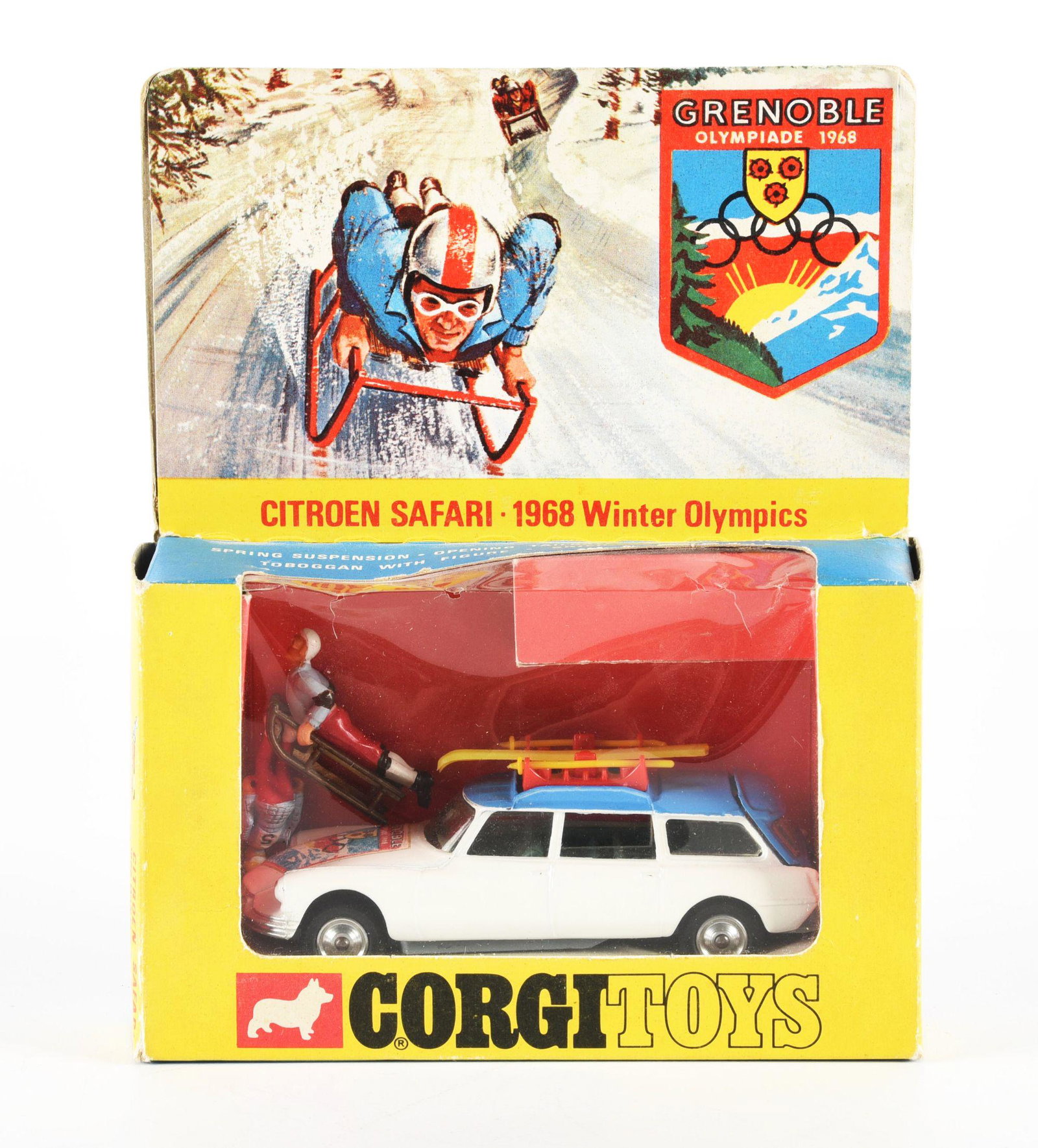 CORGI DIE-CAST TOY NO. 499.: Grenoble Olympiad 1968 Vehicle. Comes with two figures, one on sled, plus skis and poles. For the 1968 Olympics in France. Celluloid front is pushed in slightly, but not torn. Some box edge wear. Cond