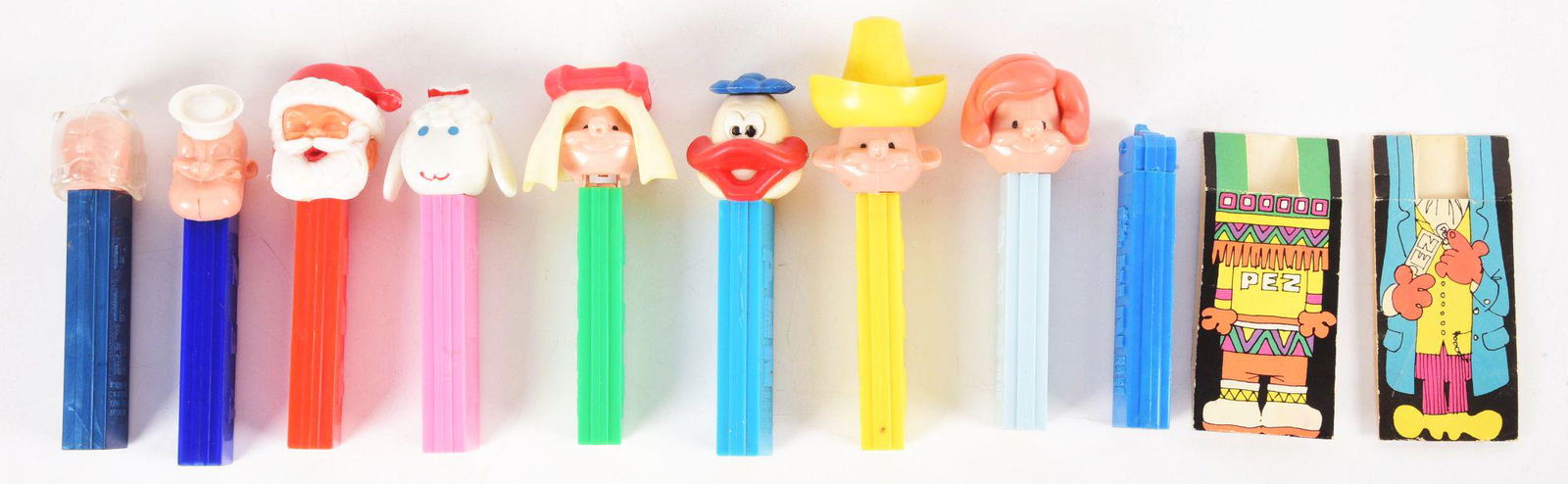 LOT OF 9: PEZ FIGURES.: All in wonderful condition. Condition: (Excellent Plus). Dimensions: Each: 1 - 1/2" x 1 - 1/2" x 4 - 1/4".
