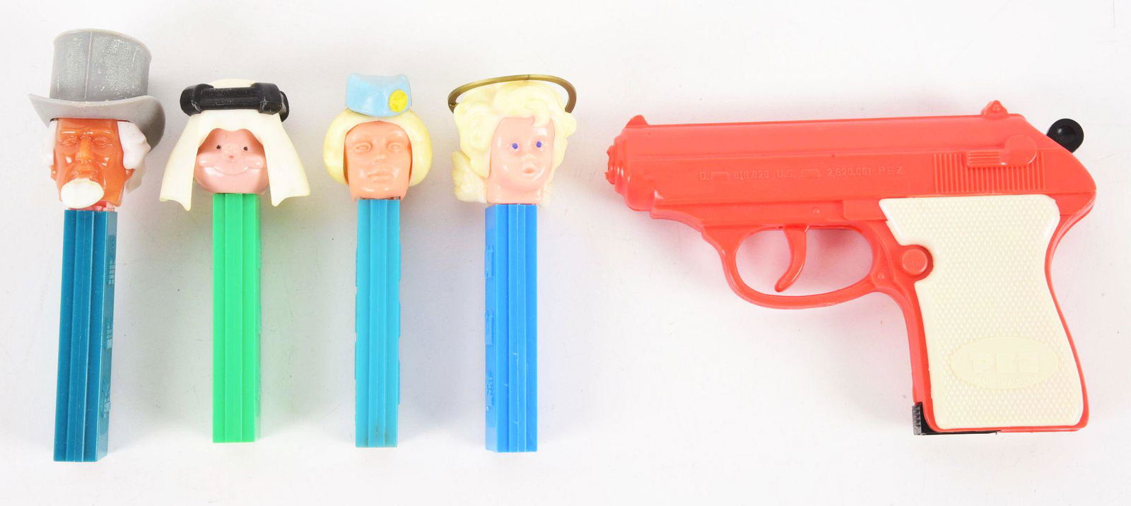 LOT OF 5: PEZ DISPENSERS.: Includes a stewardess, Uncle Sam, sheikh, angel and Pez gun. Condition: (Excellent). Dimensions: Largest: 5 - 3/4" x 3 - 7/8" x 1".