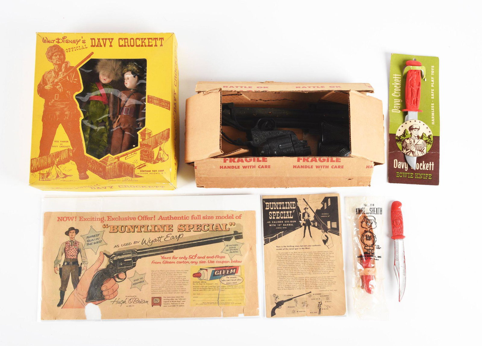 NICE LOT OF VARIOUS WYATT EARP AND DAVY CROCKETT MEMORABILIA.: Including a mail-away buntline special plastic pistol with two paper advertisements and instruction sheet for gun, a Walt Disney Davy Crockett doll set in the original box, a Davy Crockett Bowie knife