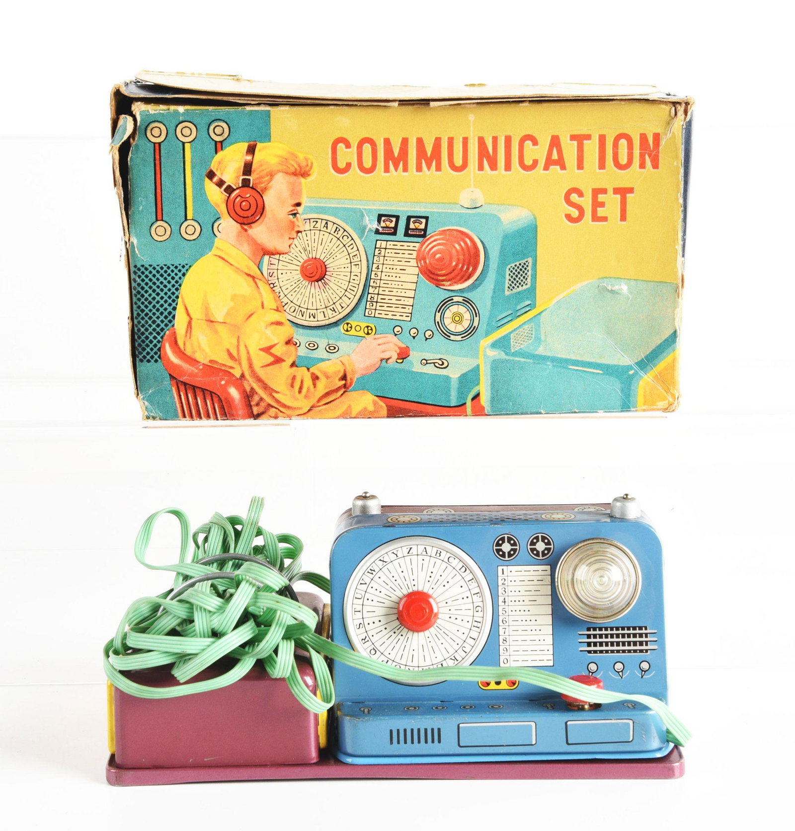 JAPANESE TIN LITHO COMMUNICATION SET IN ORIGINAL BOX.: Battery operated. Nice color litho box. Condition: (Very Good - Excellent). Dimensions: 8 - 1/4" x 4" x 4 - 3/4".