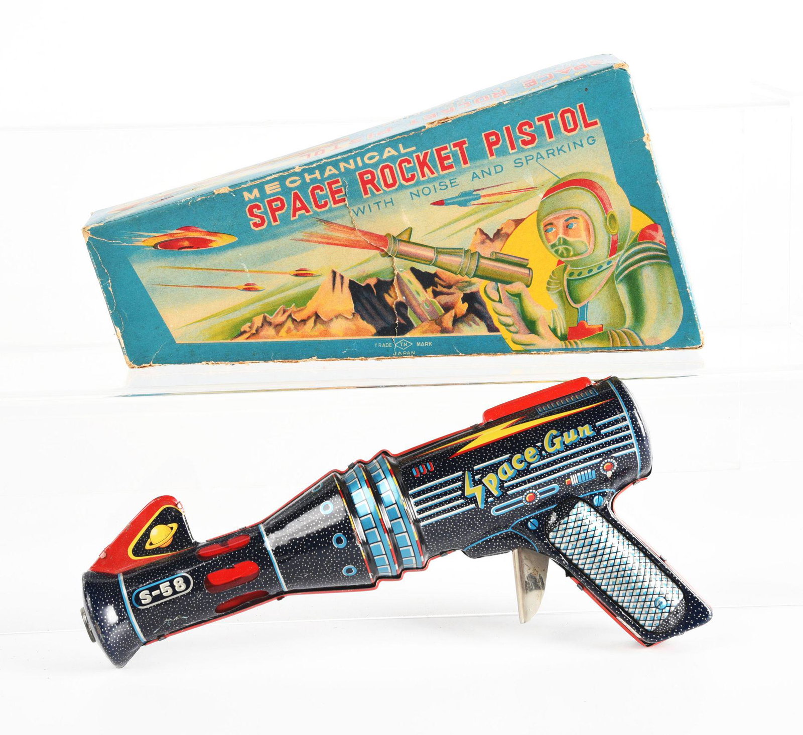 JAPANESE TIN LITHO FRICTION SPACE GUN.: In original box. Made by T.N. Nomura. Nice color graphics on box, which has some tearing on front. Gun marked "S-58" and is wind-up. Gun is in excellent condition, box is in very good condition. Condi
