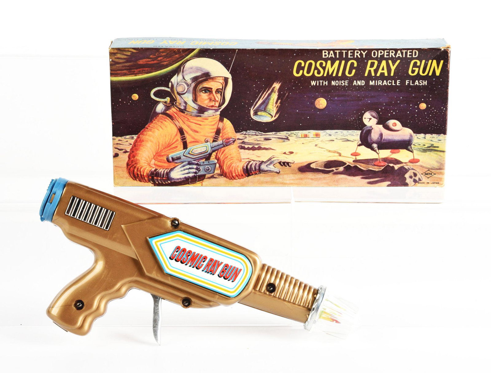 JAPANESE BATTERY OPERATEDTIN LITHO COSMIC RAY GUN IN ORIGINAL BOX.: Box marked Diya Japan. Condition: (Very Good - Excellent). Dimensions: 10 - 3/4" x 4 - 1/2" x 1 - 3/4".