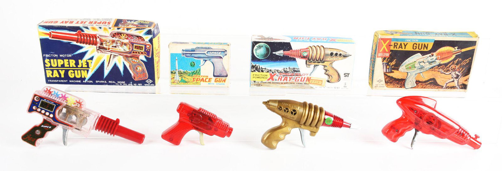 LOT OF 4: JAPANESE PLASTIC FRICTION RAY GUNS IN ORIGINAL BOXES.: 2 X-ray gun, super jet ray gun, and a small space gun. Condition: (Very Good - Excellent). Dimensions: Largest Box: 9 - 3/4" x 5 - 1/4" x 1 - 3/4".