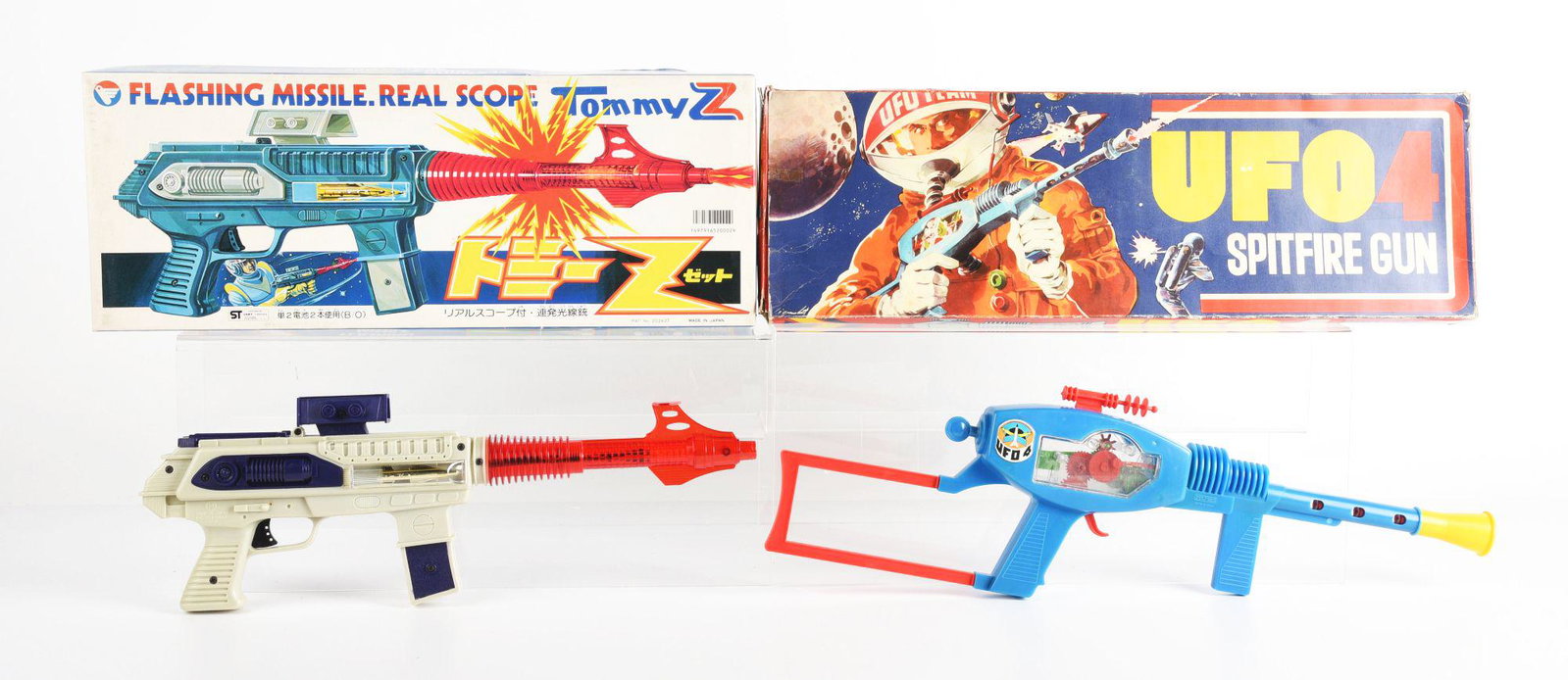 LOT OF 2: JAPANESE & ITALIAN MADE PLASTIC BATTERY OPERATED & FRICTION SPACE RIFLES IN ORIGINAL BOXES: There is an Italian ufo 4 spitfire gun and a Japanese flashing missile Tommy Z gun. Condition: (Very Good - Excellent). Dimensions: Largest: 20" x 7 - 3/4" x 2 - 1/4".