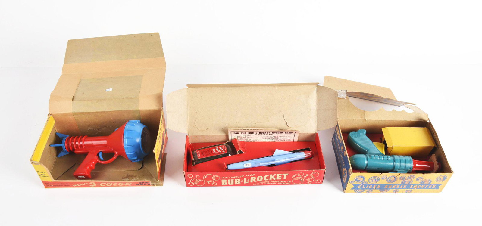 LOT OF 3: AMERICAN MADE PLASTIC SPACE AND BUBBLE ROCKET GUNS IN ORIGINAL BOXES.: There is a space ray gun made by ideal, bub-l-rocket, and clicka bubble shooter. Condition: (Very Good). Dimensions: Largest Box: 10" x 5 - 1/2" x 3 - 1/2".