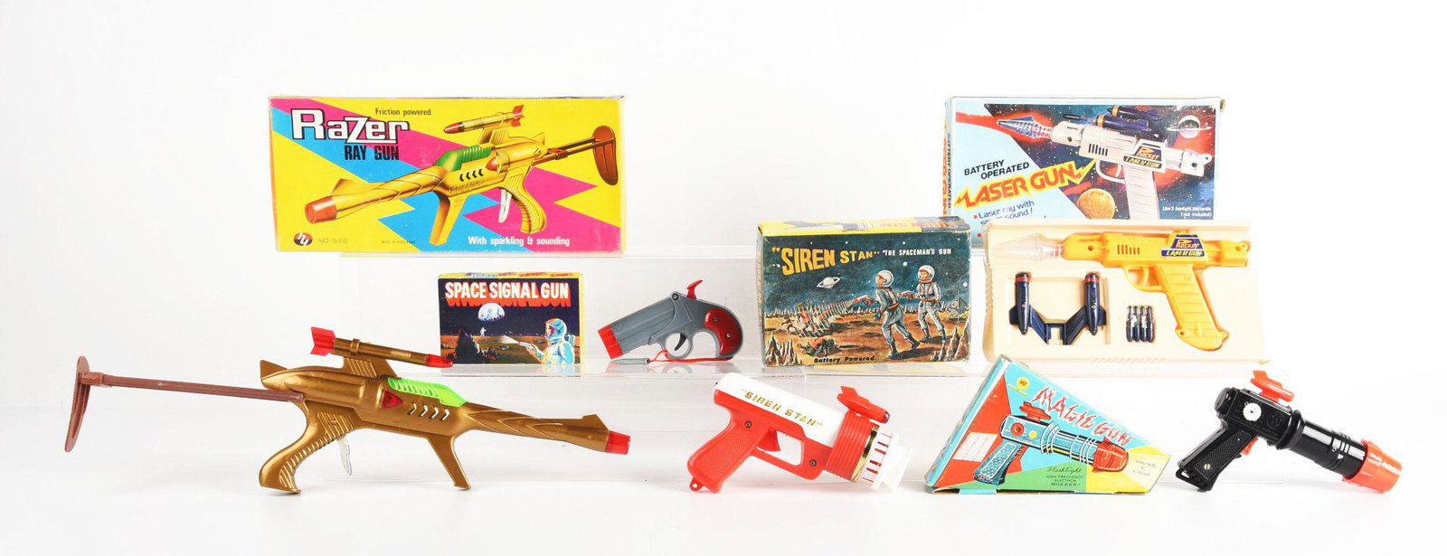 LOT OF 5: MOSTLY HONG KONG MADE PLASTIC SPACE GUNS IN ORIGINAL BOXES.: There is a razer gun, laser gun, and others. Some wear to boxes. Condition: (Very Good - Excellent). Dimensions: Largest Box: 14 - 1/2" x 6" x 1 - 3/4".