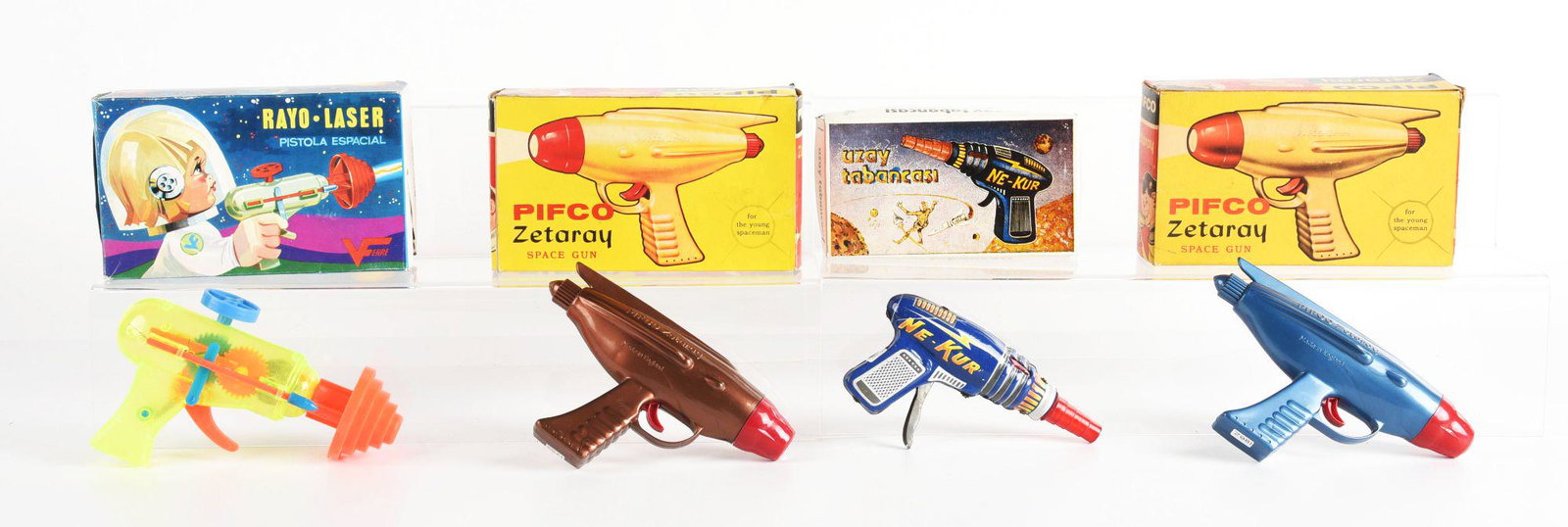 LOT OF 4: FOREIGN MADE TIN & PLASTIC SPACE GUNS IN ORIGINAL BOXES.: Made by England, Turkey, and Spain. One laser gun, ne-kur, and two other space guns. Condition: (Very Good). Dimensions: Largest Box: 7 - 1/2" x 4 - 1/2" x 2 - 1/2".