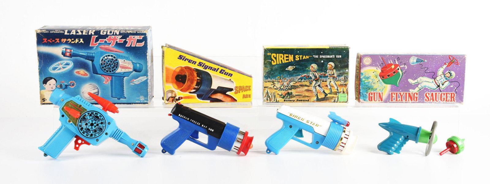 LOT OF 4: VARIOUS MOSTLY MADE IN HONG KONG PLASTIC SPACE GUNS.: All in original boxes. Mostly laser and siren guns with one flying saucer gun. Nice graphics to boxes, which do have some creasing and wear. Condition: (Very Good). Dimensions: Largest Box: 9 - 1/2" x