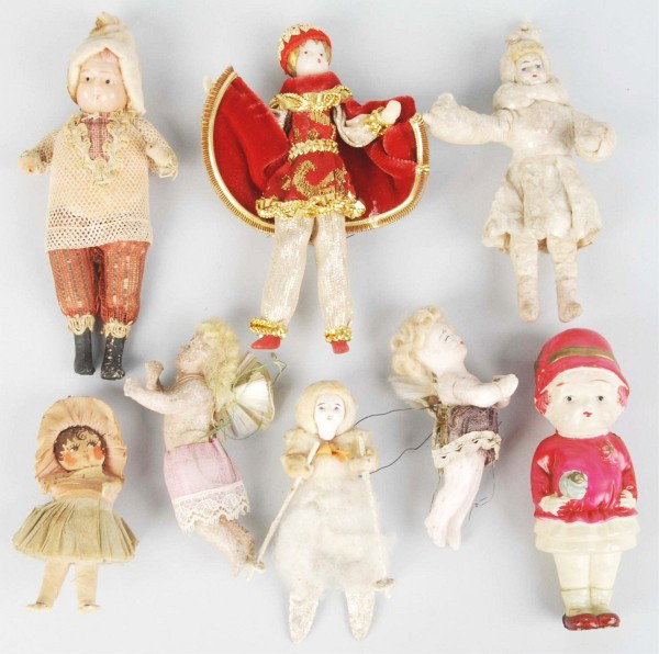 Lot of 8: Figural Child Christmas Ornaments.: Includes two wax angels with glass and wire wings, one celluloid young girl (made in Japan), one cotton child with composition face, and others. Condition (Very Good - Excellent)."