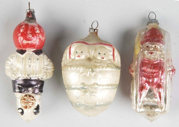 Lot of 3: Figural Ornaments.: Includes a Halloween pumpkin head with a full body and a soccer ball at his feet, two babies in a basket, and a boy holding a sled on his back. Nice early glass ornaments. Condition (Very Good - Excel
