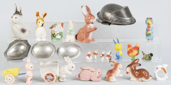 Lot of 15+ Easter Decorations & Candy Containers.: Includes one German bunny pulling cart, several chocolate egg metal forms, and one Japanese toothpick holder with bunny. Condition (Very Good - Excellent). Size Largest: 6 - 3/4"" T."