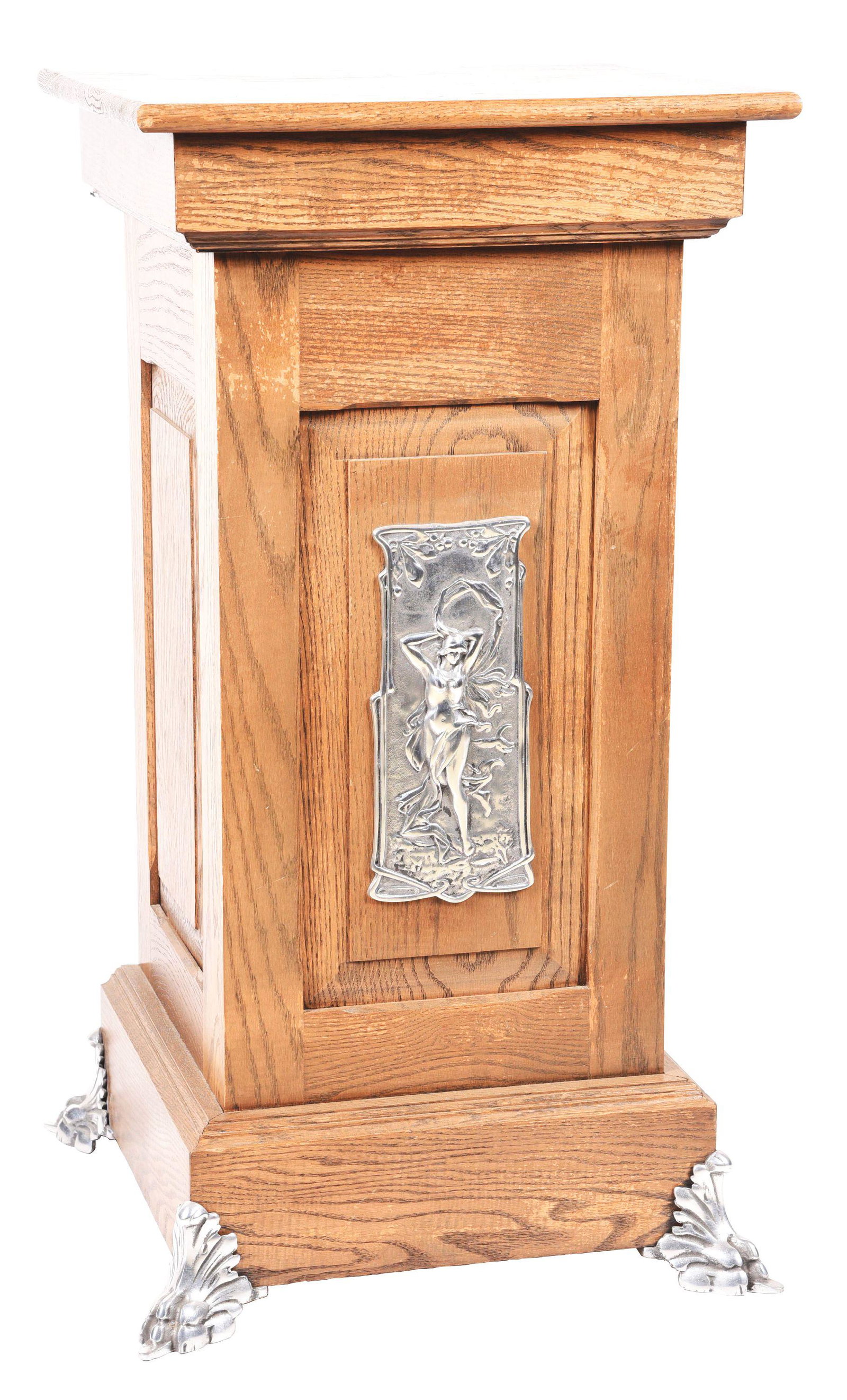 OAK SLOT MACHINE STAND.: A single slot machine stand, made up of oak with cast aluminum components such as the claw legs. Featured is a relief of a nude woman with robes, draped around her body. CONDITION: The finish on the w