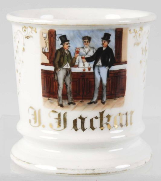 Bartender Scene Shaving Mug.: Gilt name "J. Jackan". Shows a bartender with two customers with top hats. Numbers "43" and "87" on bottom. No cracks, chips, or repairs noted but some moderate gold loss to top and bottom rims. Condi