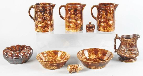 Lot of 9: Bennington Pottery Pieces.: Lot includes four pitchers, two bowls, one spittoon, and one pig bank. Pitchers have a few minor chips. Condition (Excellent).