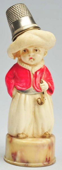 Boy Holding Pipe Tape Measure & Thimble Holder.: German. Celluloid and metal thimble. Original full tape. Condition (Excellent). Size 3 - 1/2" T.