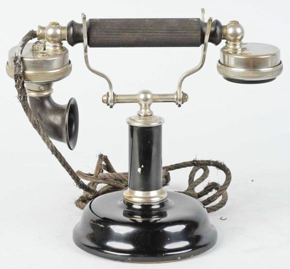 American Electric No. 46 Cradle Set.: Circa 1915. Black and nickel, marked on the transmitter, and frayed cords. Condition (Excellent). Size 8" T.