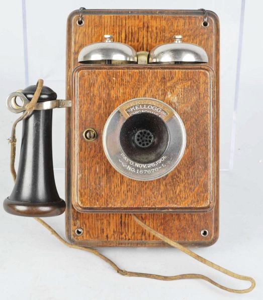 Oak Kellogg Common Battery Hotel Telephone Set.: Circa 1905. Phone has an early marked receiver and faceplate. Unusual marked number card holder and frayed cord. Condition (Excellent). Size 10 - 1/2" T.