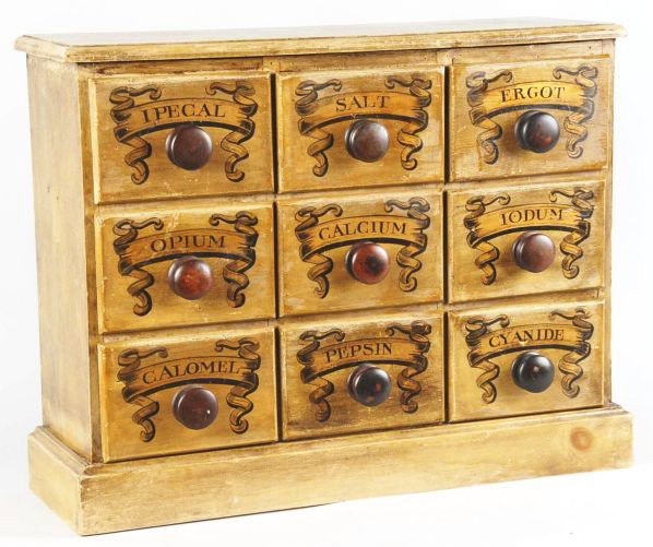 Apothercary Cabinet with 9 Drawers.: Light brown wooden apothecary cabinet with painted decorative labels. Condition (Good - Excellent). Size 22 - 1/2" x 29" x 9 - 1/2".