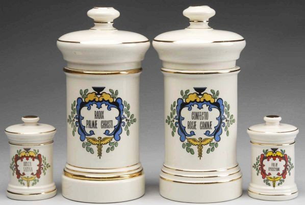 Lot of 4: Gilded Porcelain Apothecary Jars.: Circa 1950 to 1970. Four porcelain apothecary display jars marked "Fashioned by Blair" on bottom Cream colored with gold trim. Graphics in red (small jars) or blue (large jars) with black letters. Lab