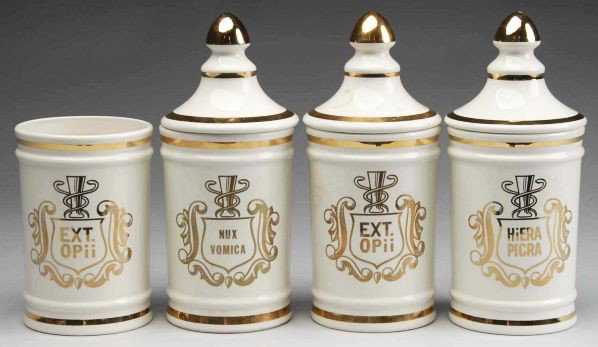Lot of 4: Gilded Porcelain Apothecary Jars.: Matching set of mid-20th century porcelain apothecary display jars. White with gold trim, graphics, and lettering. Distributed by Owens-Illinois. Two EXT OPii (one missing lid) jars, one NUX VOMICA, o