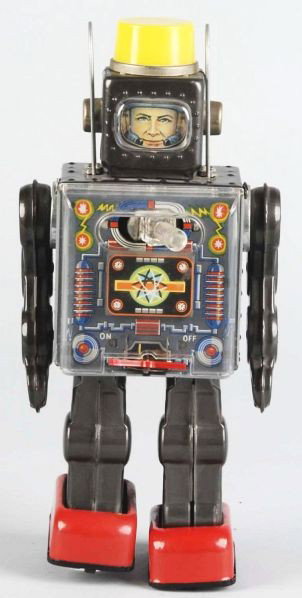 Attacking Spaceman Battery-Op Toy.: Japanese. Working. Original plastic shield in front with no cracking. Toggle switch on chest. When in operation, spaceman fires gun out of his chest. Battery box is clean. Some scratching, overall wea
