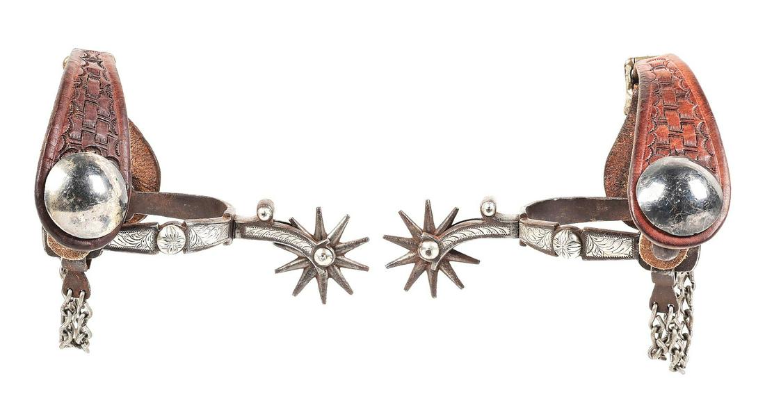1920S LADIES SILVER WESTERN SPURS.: Single mounted ladies style California spurs. Outside heel band features 2 sterling silver panels with fine hand engraved leaf patterns with a center floral etched concho. Inside band is plain iron. N