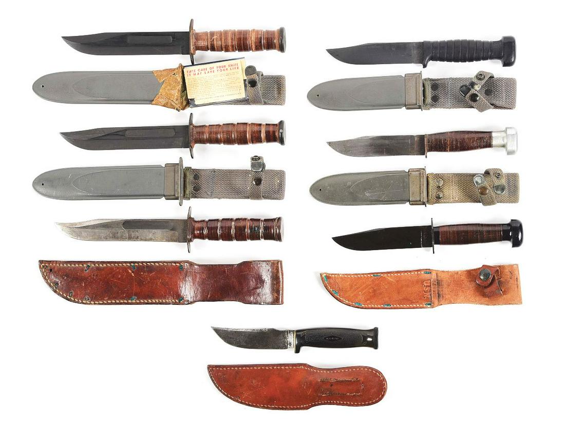 LOT OF 7: US WWII FIGHTING KNIVES.: Lot consists of: (A) World War II U.S.N. Mark 2 knife by Camillus with appropriate ricasso markings, complete with blue fiberglass scabbard. The knife is also accompanied by original care instruction.