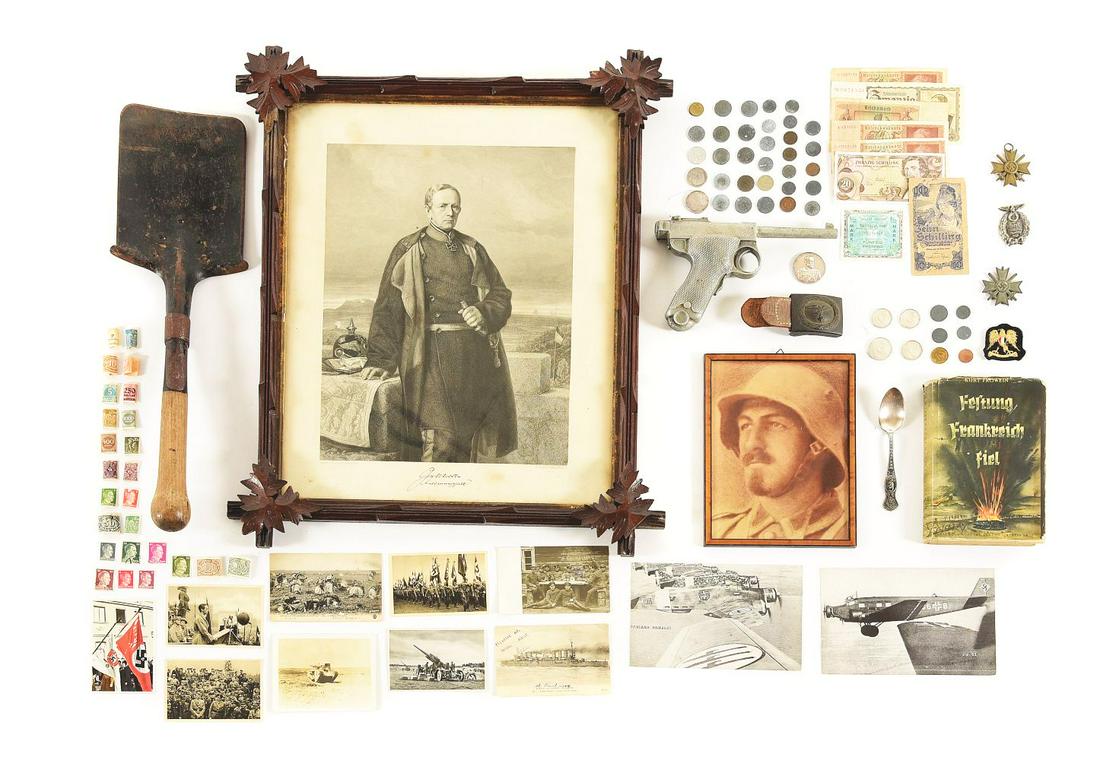 LOT OF MISCELLANEOUS GERMAN WWI-WWII EPHEMERA.: Lot contains a framed copy of a WWI photo, a WWII book about "Fortress France", Swiss Army shovel, post-WWI paper currency, WWII zinc coins, 2 War Merit crosses, Luftwaffe buckle, silver spoon, framed