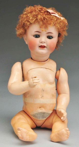 Mechanical K & R 126 Character Baby Doll.: Description German bisque socket head incised Simon & Halbig 126, multistroked eyebrows, curly brown caracul wig, blue glass eyes are stuck half open, open mouth with wiggly tongue; composition baby b