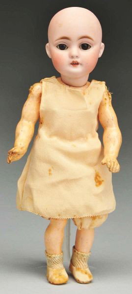 Kestner 143 Child Doll.: Description German bisque socket head incised "3 made in Germany 0 143." Multistroked eyebrows, dark sleeping eyes open mouth with molded upper teeth; original composition body with joints at shoulder