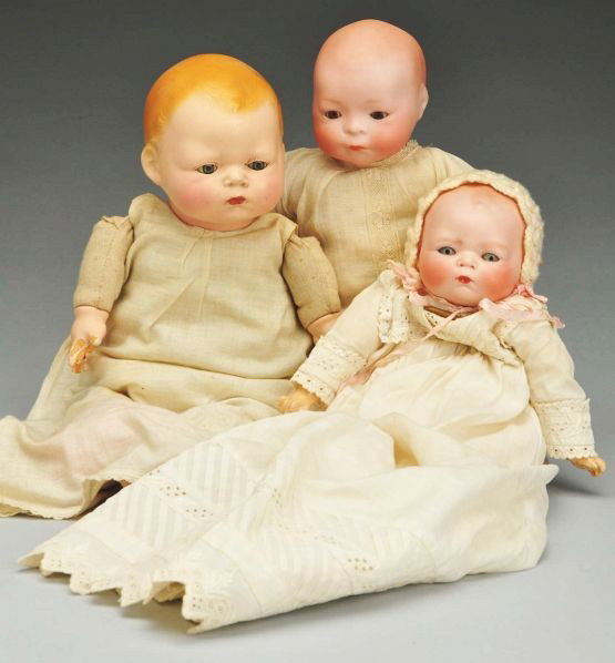 Lot of 3: Baby Dolls.: Description All with cloth bodies and composition hands (crazing). Bisque head Century Baby with sleeping eyes, frown expressing, nice antique baby gown; Amberg "Newborn Babe" with bisque head, sleepi