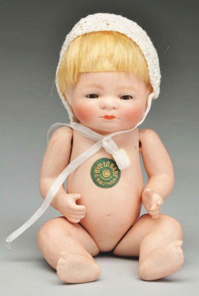 All Bisque "Bye-Lo Baby" Doll.: Description Fully incised on back "Copr by Grace S. Putnam Germany" and with green paper label on torso. Original mohair wig, glass sleeping eyes, original blonde mohair, closed mouth. Jointed shoulde