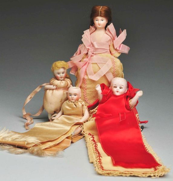 Lot of 4: All Original Sewing Companion Dolls.: Description Kestner all-bisque girl with painted features, swivel neck, in pincushion dress (some deterioration to silk); Kling 36 all-bisque girl with yellow boots in a pins and needle case (no wig);