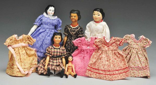 Lot of Hitty Artist Dolls.: Description Hitty signed H.K. feels like it's waxed; wood Hitty by Judy Conroy 1997; Lotz basswood Hitty #5 1998; small wax? Hitty; Rosemary Snyder china Hitty; 4 additional cotton dresses. Condition