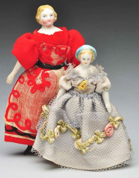 Pair of Doll House Dolls.: Description German parian bisque shoulder head dolls with cloth bodies and bisque lower limbs. Small lady has rare hairdo with turquoise snood and blonde hair (bisque is splotchy), original body with