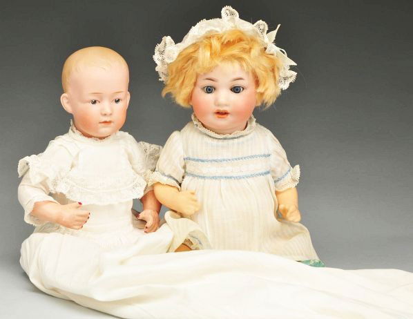 Lot of 2: German Bisque Baby Dolls.: Description Both are characters with bisque socket heads, composition bodies and well-dressed. Beautifully modeled Gebruder Heubach head with intaglio eyes, black eyeliner and white dot highlights, cl
