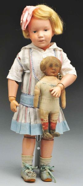 Sweet Schoenhut Character Doll.: Description All wood and spring jointed with Schoenhut mark. Original face paint (overall crazing, teeny flake on nose and upper lip), original mohair wig, dark blue intaglio eyes, pouty mouth (lips f